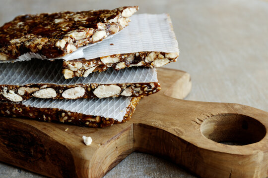 Turron nougat dessert with almond nuts and sesame seeds with honey close-up.