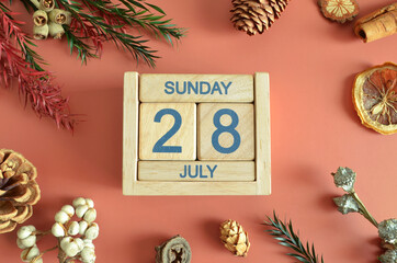 July 28, Cover design with calendar cube, pine cones and dried fruit in the natural concept.	
