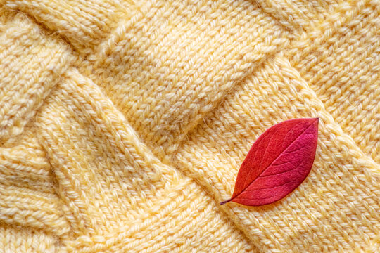 yellow knitted with large patterns, textured background