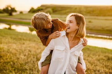 White sister and brother piggybacking and making fun