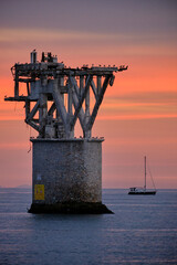 A mine tower at the sea in a sunset