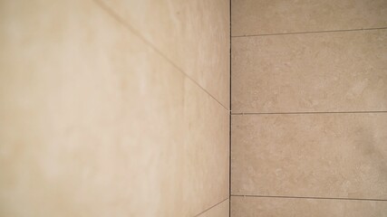 Tiles on the walls. Laying tiles on walls and floor. Bathroom tiles on the wall.