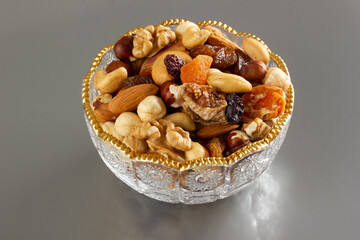 Mixed nuts in a glass plate. Healthy and natural nutrition .Cashew, Almond,, Hazelnut,, Fig,, Walnut,, Apricot,, Raisin,, Blueberry.