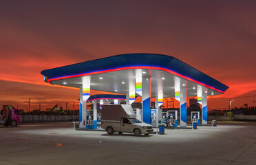 Fototapeta na wymiar Gas station at sunset.