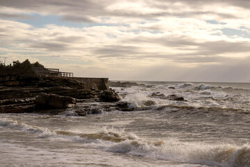 on the beach in the morning with cliffs