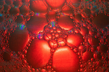 Water drops mixed with detergent on a color background