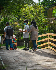 Family spending day at the zoo. Farm in the city.