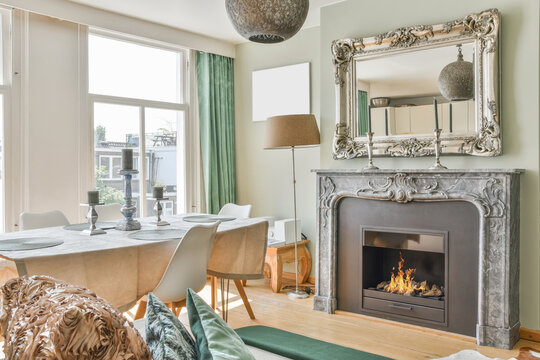 Dining room interior with fireplace and mirror at home