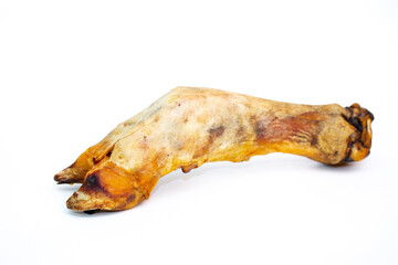 A treat for pets. Pork hoof on a white background, dried bone for cleaning dogs teeth.