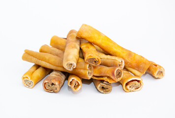 A treat for pets. Veins and skin rolled into a roll on a white background, dried bone for cleaning dogs teeth.