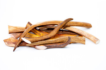 Deer antlers on a white background, dried bone for cleaning dogs teeth. A treat for pets.
