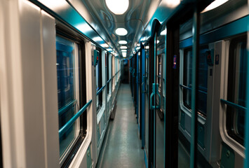 Blue hallway inside of a classic train with private rooms