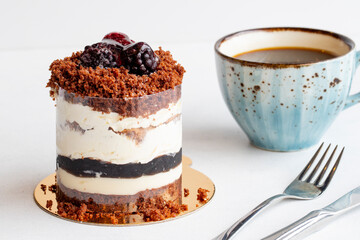 Blueberry mois cake on a white background. Along with a cup of coffee