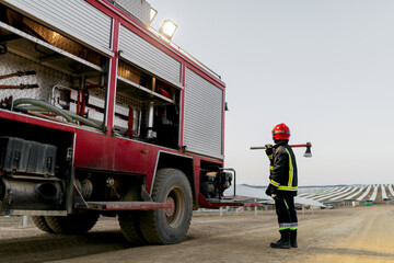 Firefighter standing near fire engine