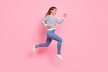 Fototapeta na wymiar Full size profile photo of young funny brown hairdo lady run wear shirt jeans sneakers isolated on pink background