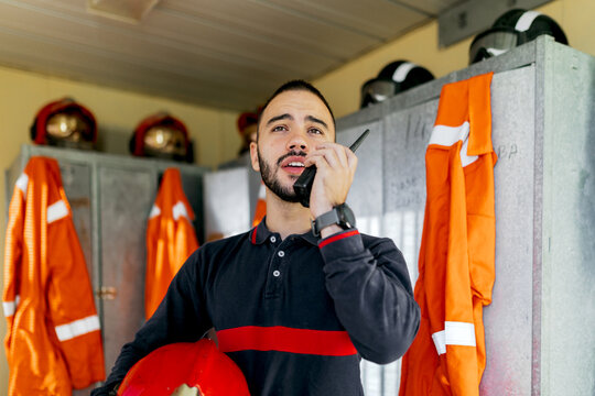 Young firefighter speaking into radio