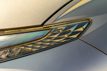 Headlight lamp of new cars. Close up detail on one of the LED headlights modern car. Exterior closeup detail. Closeup headlights of car.
