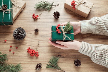 Woman making Christmas decoration on the table