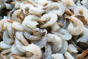 Close-up of raw defrosted peeled shrimp. Shrimp background with blurred focus