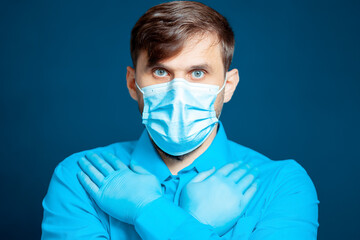 a young doctor in goggles and a medical mask crossed her arms in front of her.