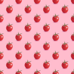 Seamless repetitive pattern with cherry tomatoes on pink background. Minimal food background.
