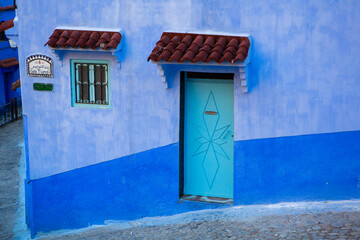 Chefchaouen, Morocco - 6 October, 2021: Blue street and houses in Chefchaouen, Morocco. Beautiful colored medieval street painted in soft blue color.