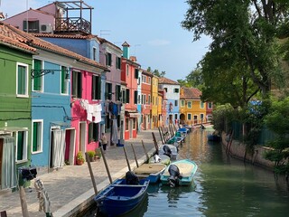 Fototapeta na wymiar Boats and colorful traditional painted houses in a canal street houses of Burano island, Venice, Italy