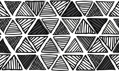 Doodled tribal pattern in monochrome colors. This updated tribal motif features hand-drawn triangles in a repeating pattern.