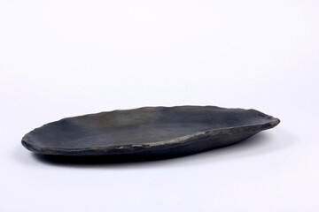 black clay plate on a white background