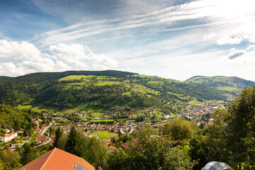 Landscape of town in valley  and clouds in a blue sky, La Bresse, Vosges, France