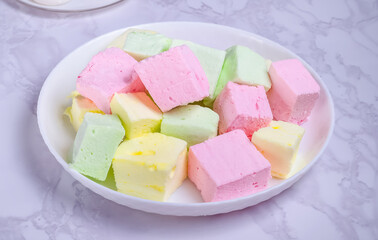 Dessert multicolored souffle marshmallow on a white plate
