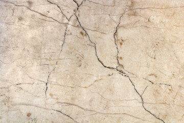 Close-up photo texture of worn and cracked marble wall.