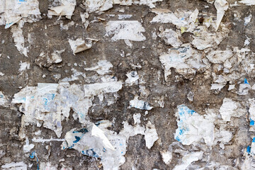 Photo texture of grunge concrete wall with torn paper surface.