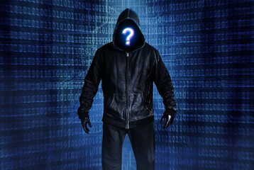 Photo of hacker person in black hood and clothing on digital binary code background.