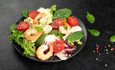 Fresh seafood salad. Grilled shrimp, fresh vegetable salad and egg. Fried shrimps. Healthy food on stone background