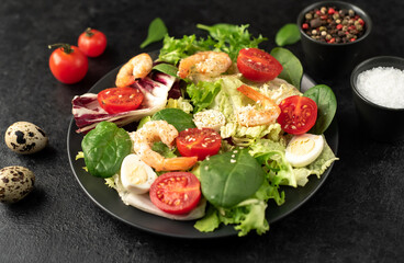 Fresh seafood salad. Grilled shrimp, fresh vegetable salad and egg. Fried shrimps. Healthy food on stone background