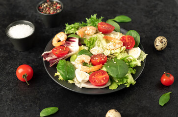 Fresh seafood salad. Grilled shrimp, fresh vegetable salad and egg. Fried shrimps. Healthy food on stone background