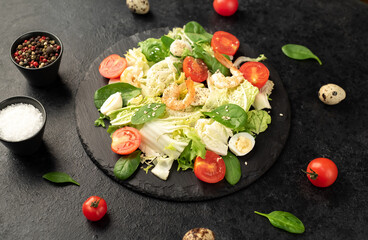 Fresh seafood salad. Grilled shrimp, fresh vegetable salad and egg. Fried shrimps. Healthy food on stone background
