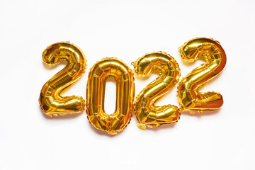 2022 golden foil balloons on white background. Gold helium balloon numbers. Happy New Year 2022.