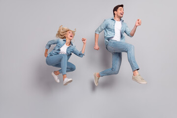 Fototapeta na wymiar Full length body size view of beautiful handsome friends friendship jumping running isolated over grey pastel color background