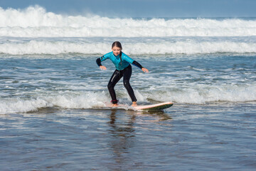 cute little girl taking a surf lesson - 463115664