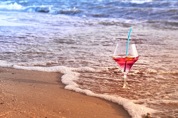 Wine glass with a cocktail by the sea.