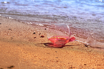 Wine glass with a cocktail by the sea.