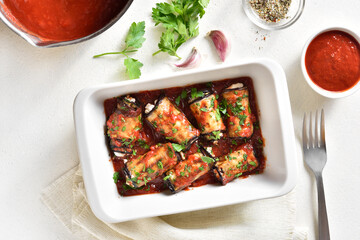 Baked eggplant rolls with tomato sauce and cheese