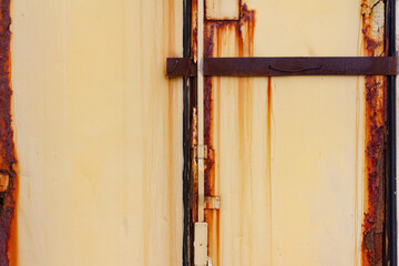 Texture photo of worn and rusty orange colored steel panels.