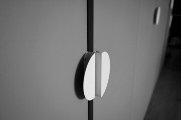white round handle from gray cabinet