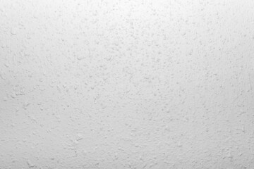 Close-up photo of white colored stucco wall texture.