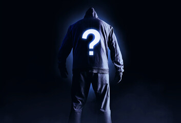 Fototapeta na wymiar Photo of scary horror stranger stalker man in black hood and clothing on dark background with glowing question symbol on his back.