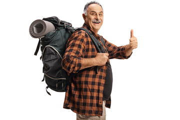Smiling mature hiker with a backpack showing thumbs up