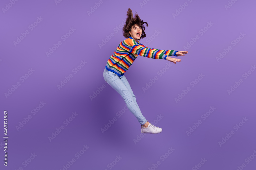 Sticker Photo of inspired carefree lovely lady jump have fun wear striped sweater jeans footwear isolated purple color background